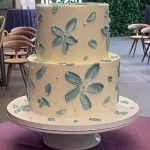 A gorgeous bespoke palette knife textured wedding cake with hand-painted details, crafted by Haryanti at Lezat Cakes in Manhattan Beach, CA.