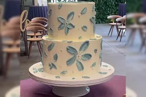 A gorgeous bespoke palette knife textured wedding cake with hand-painted details, crafted by Haryanti at Lezat Cakes in Manhattan Beach, CA.